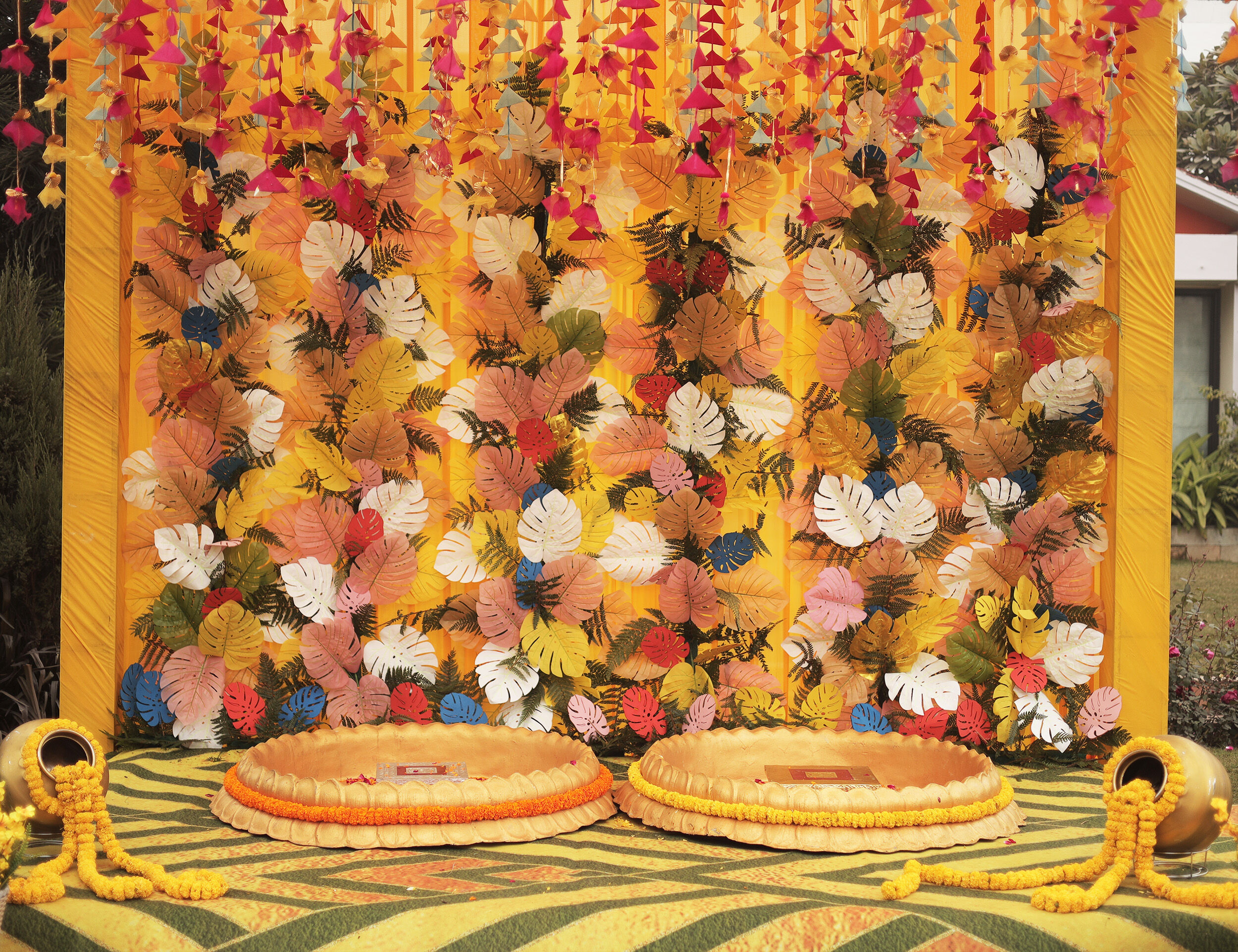 Bright yellow-themed wedding shower setup adorned with colorful leaves and elegant decor.